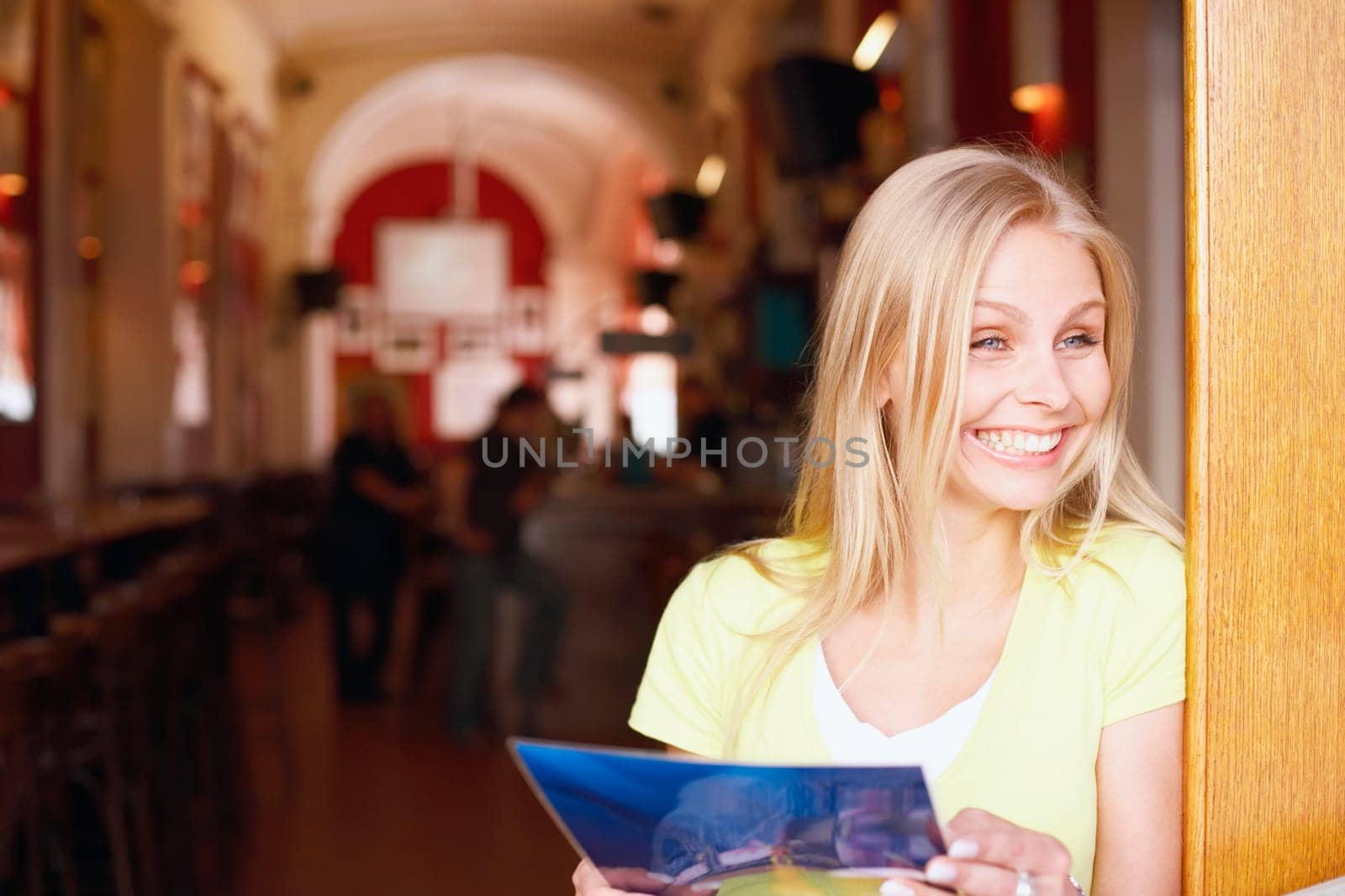 Close-up of a young woman holding a menu card