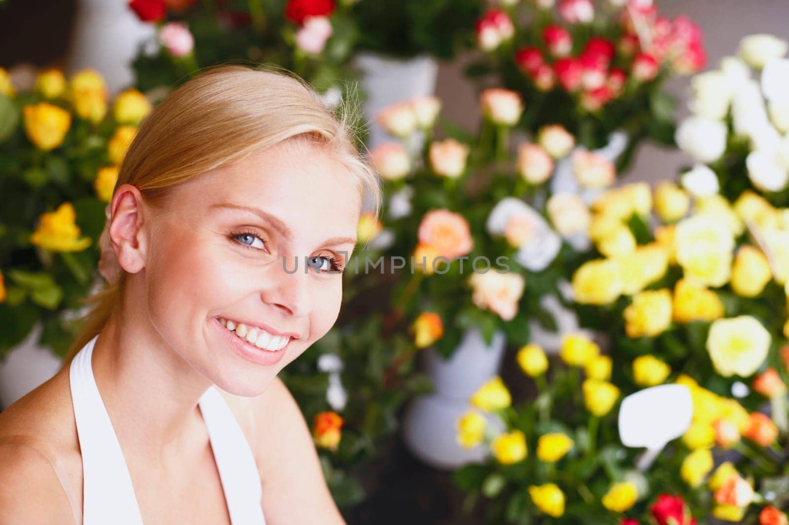 Portrait of a young woman smiling in a flower shop