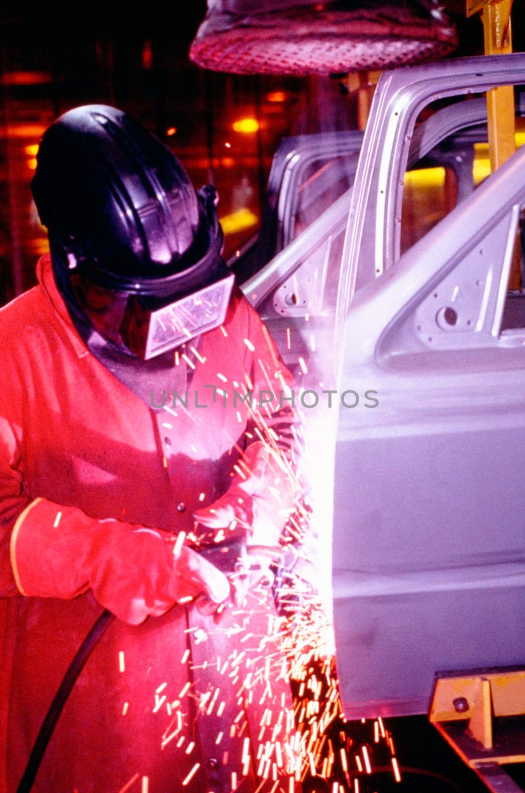 Welder working on car doors in an assembly line, Newark, Delaware, USA