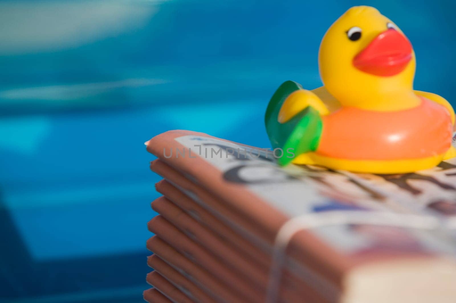 Close-up of a rubber duck on a stack of books