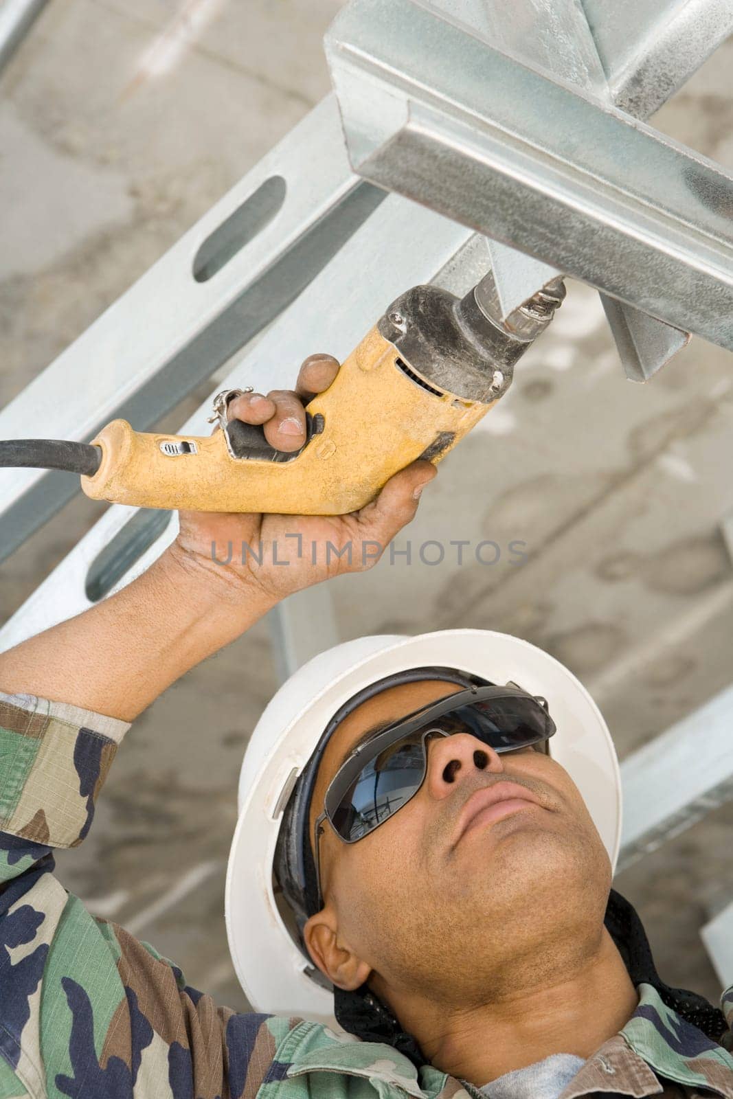 Close-up of a male construction worker working with a hand drill