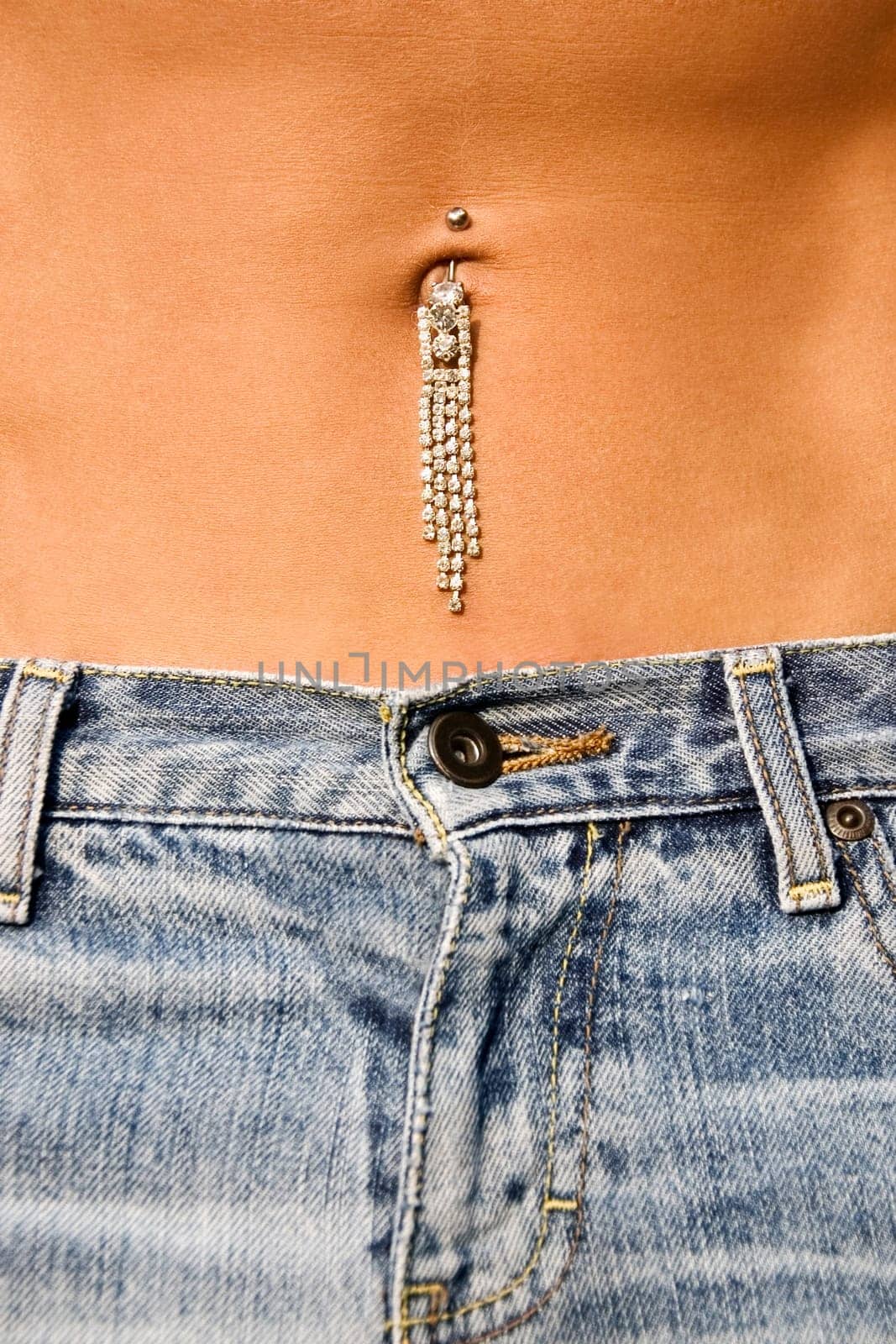 Mid section view of pierced navel of a gay man