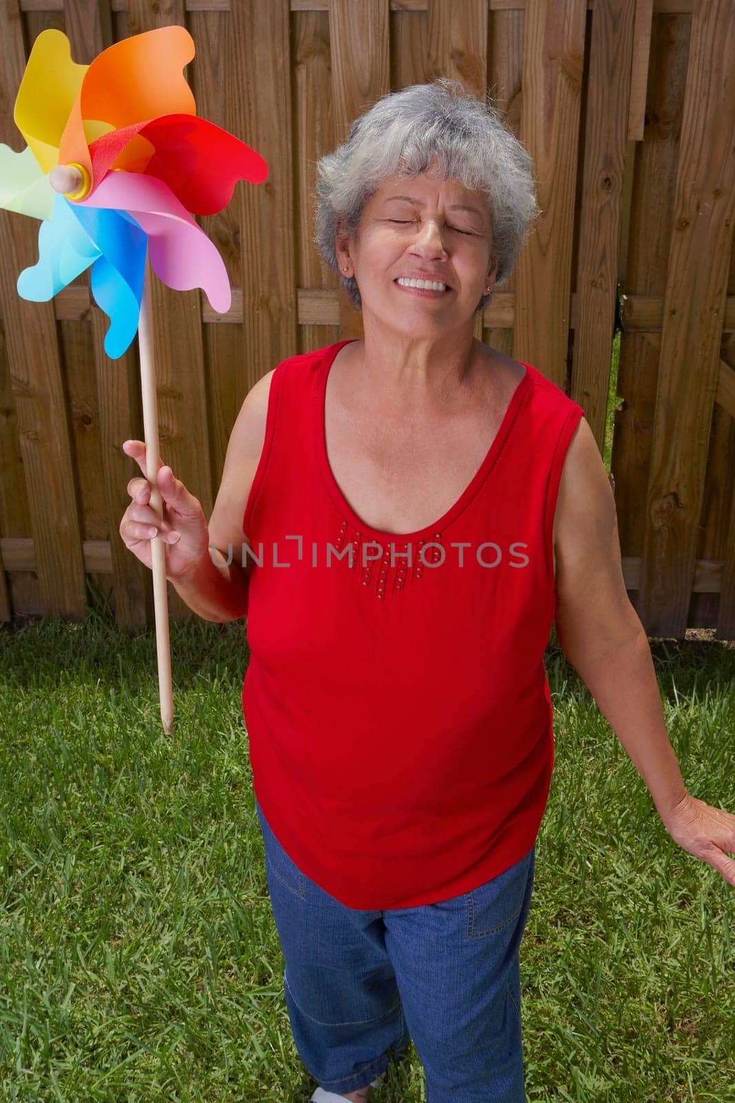 Close-up of a senior woman holding a pinwheel