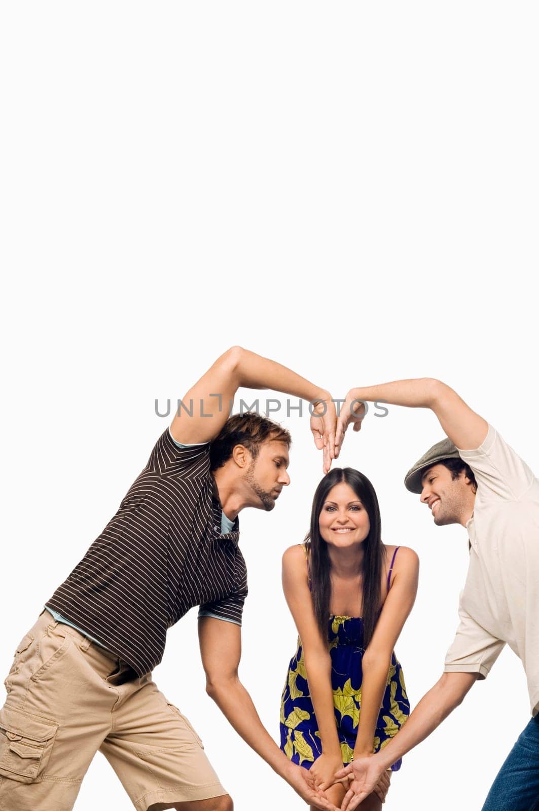 Mid adult man and a young man making a heart shape in front of a young woman