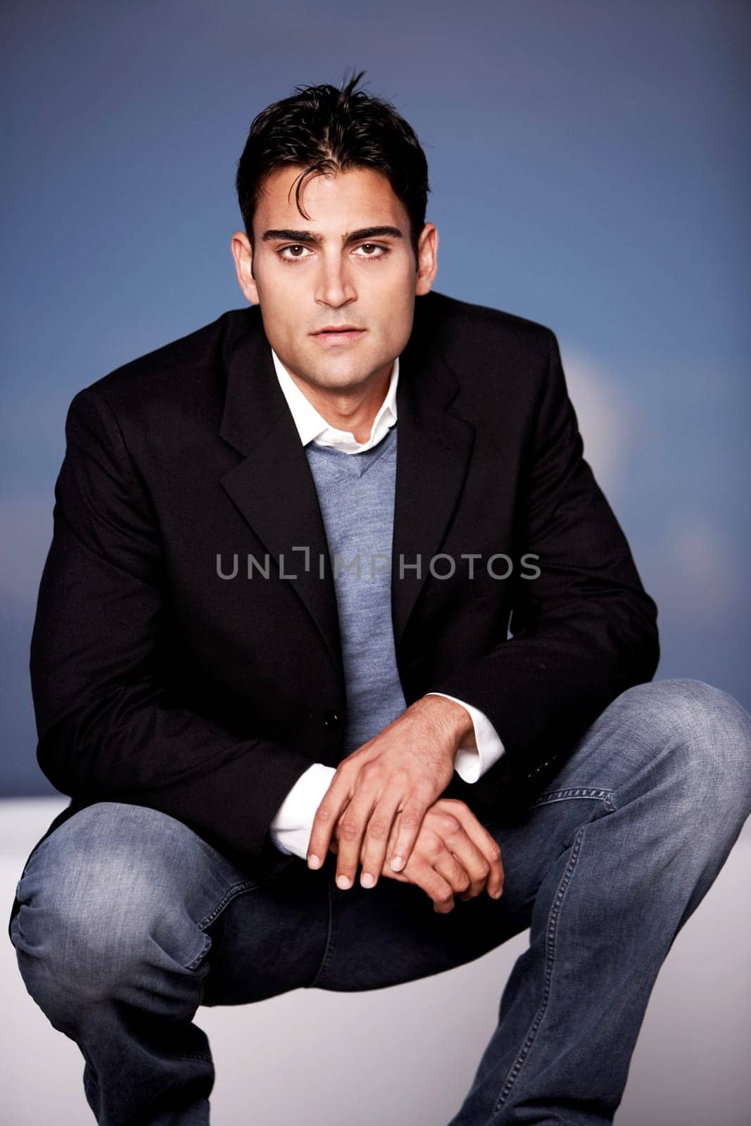 Portrait of a young man crouching
