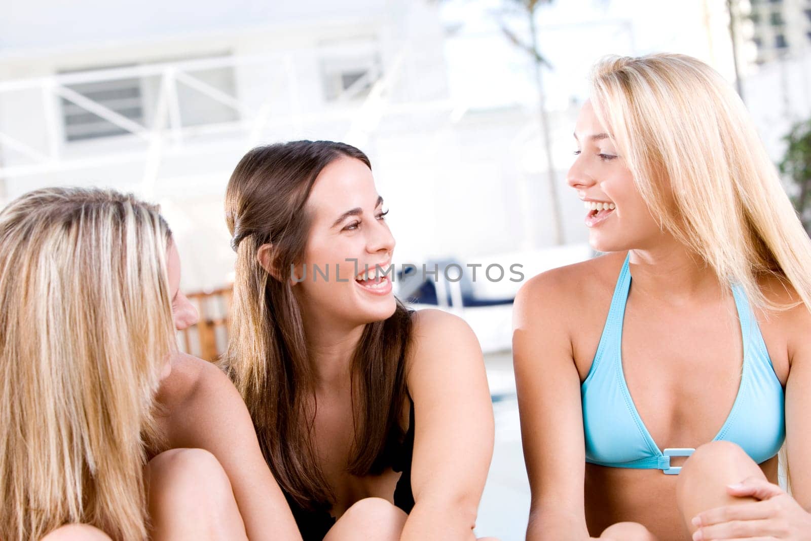 Close-up of three young women laughing