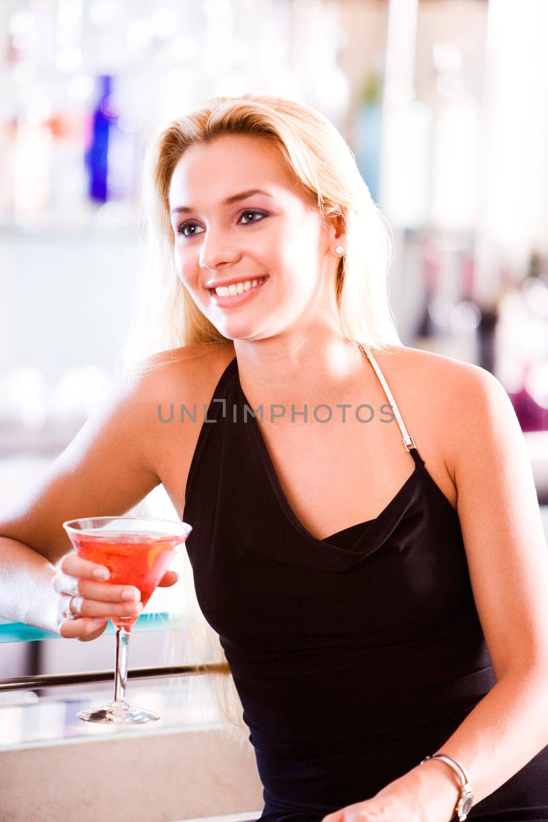 Close-up of a young woman holding a glass of martini