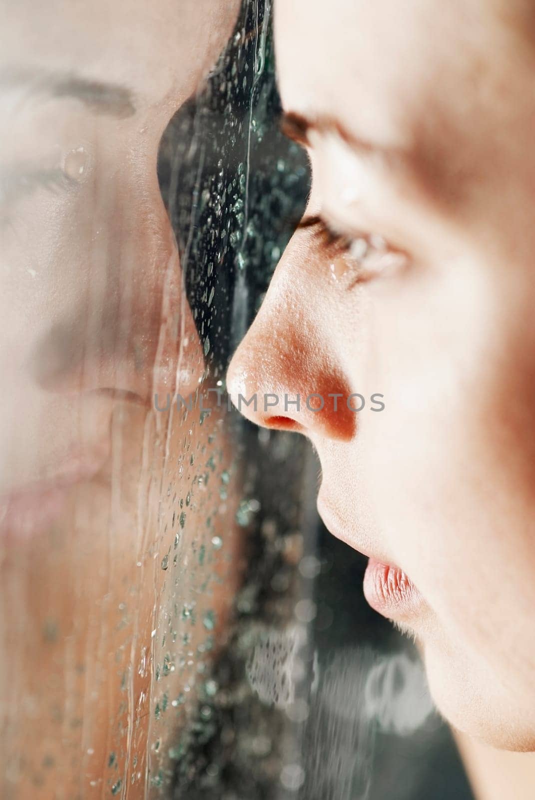 Reflection of a young woman on a glass surface