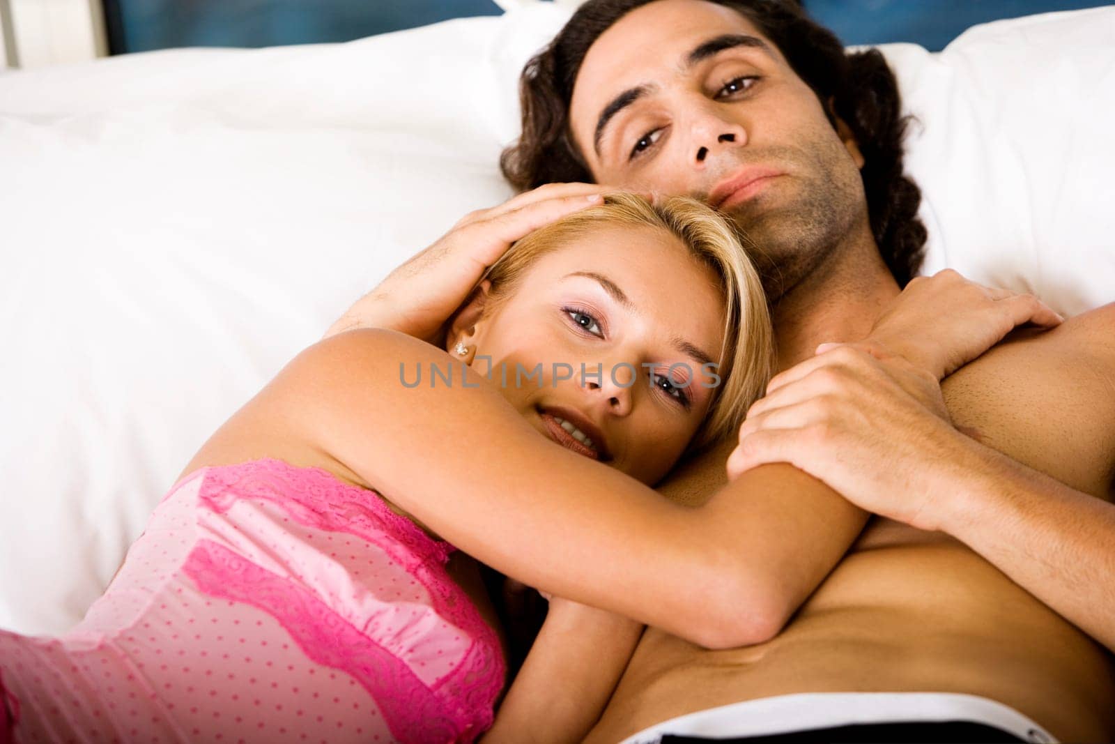 Close-up of a young couple lying on the bed