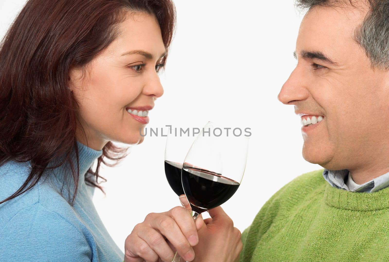Close-up of a mid adult couple toasting glasses of wine