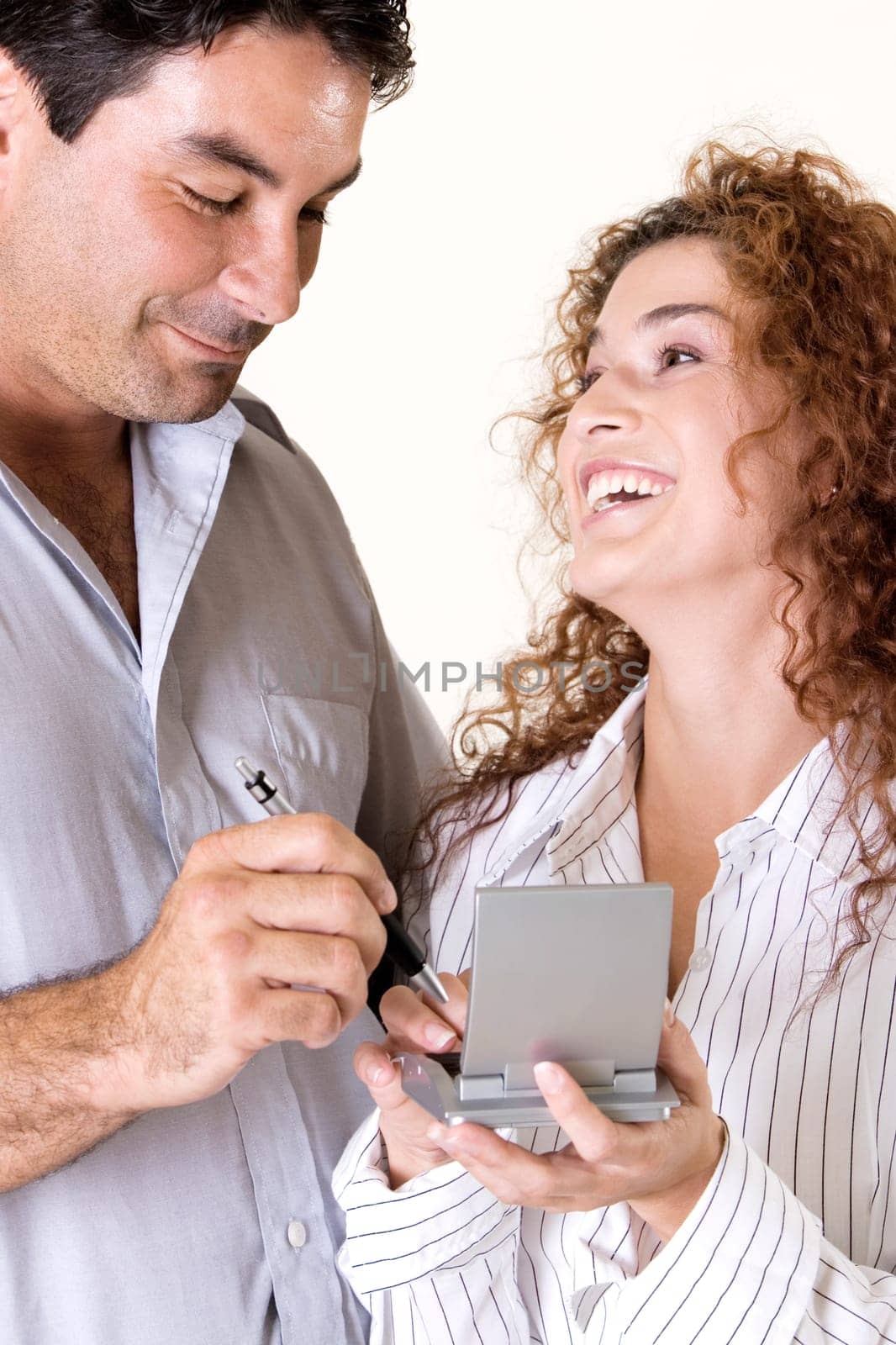 Close-up of a young woman and a mid adult man using a calculator