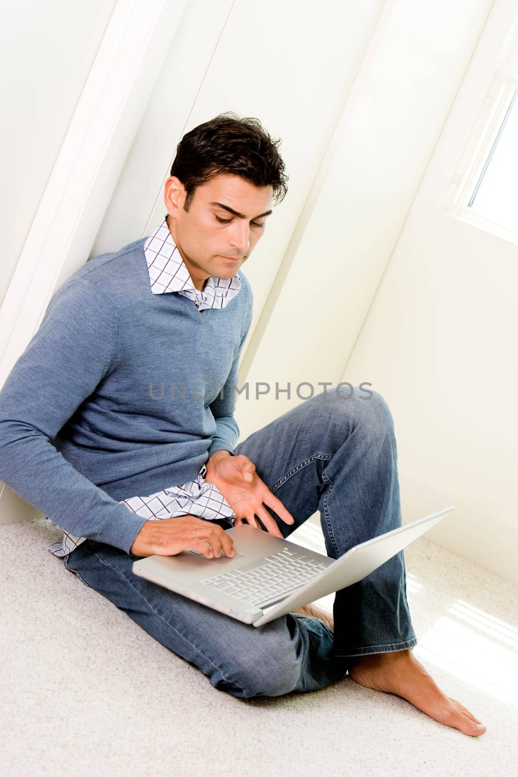 High angle view of a mid adult man using a laptop