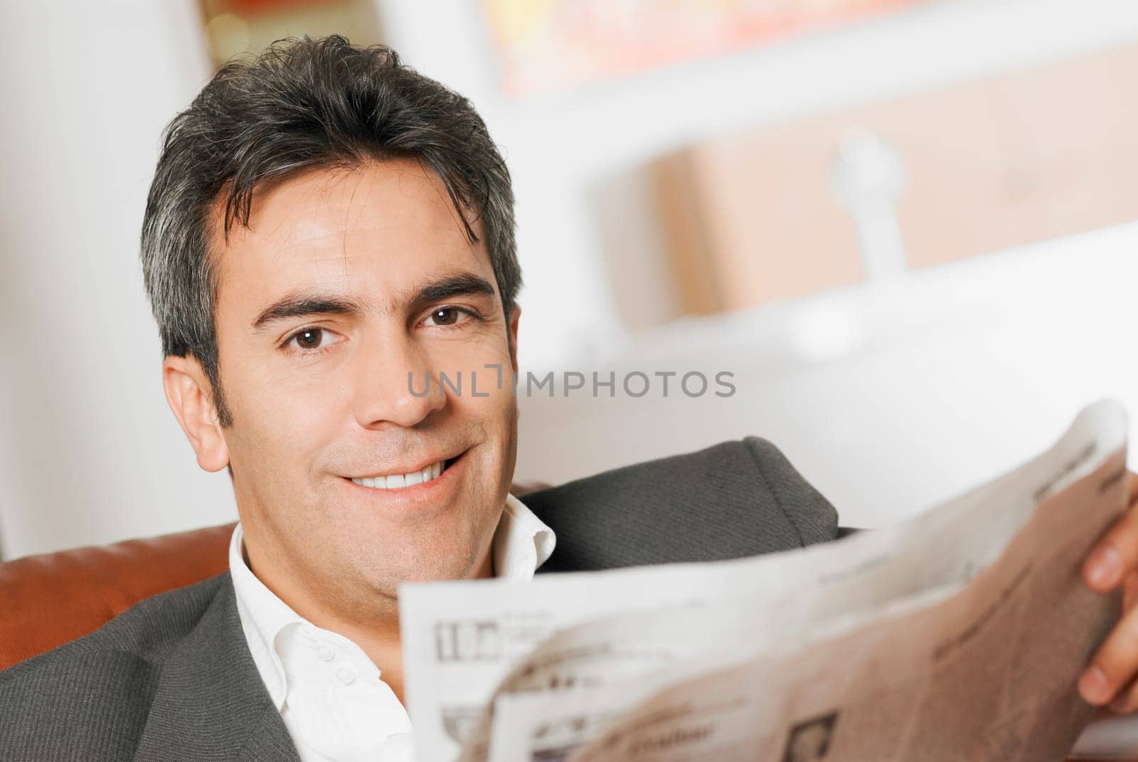 Portrait of a mature man reading a newspaper