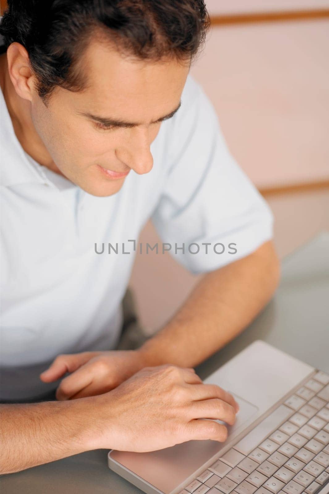 High angle view of a young man using a laptop