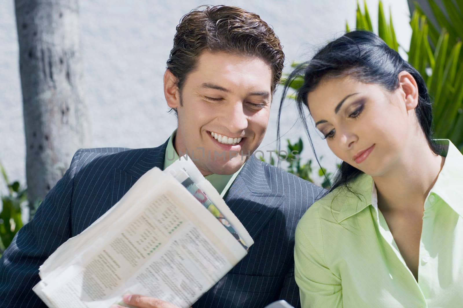 Close-up of a businessman with a businesswoman and smiling