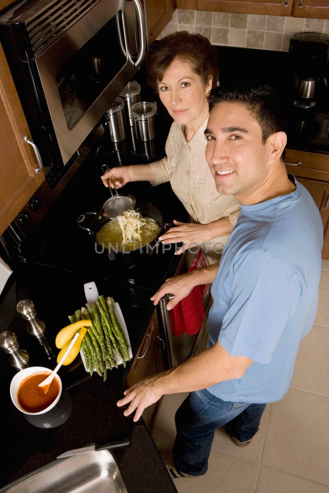 High angle view of a mid adult man with his mother in the kitchen