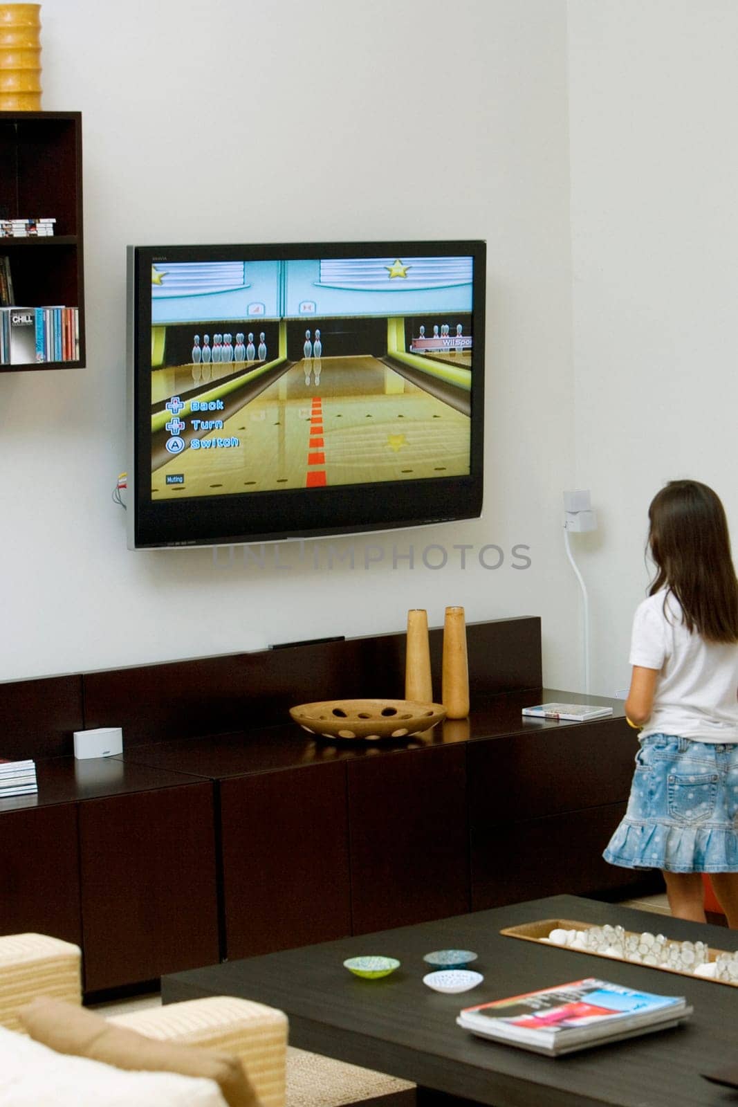 Rear view of a girl watching television