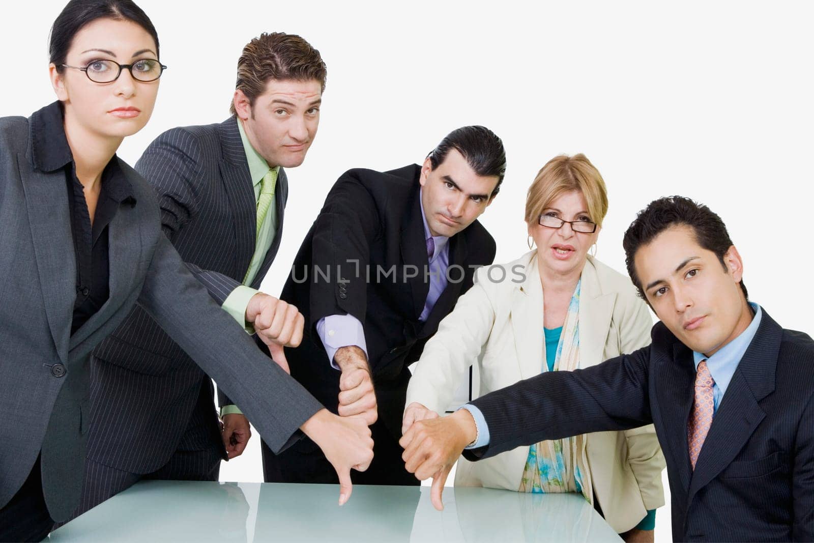 Portrait of two businesswomen and three businessmen showing thumbs down sign