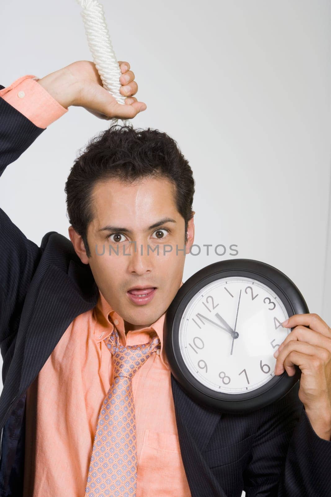 Portrait of a businessman holding a noose and a clock