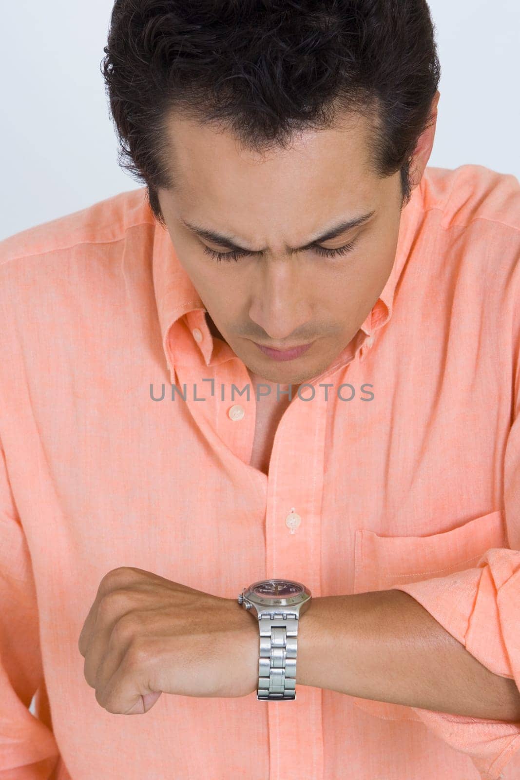 Close-up of a young man looking at his watch