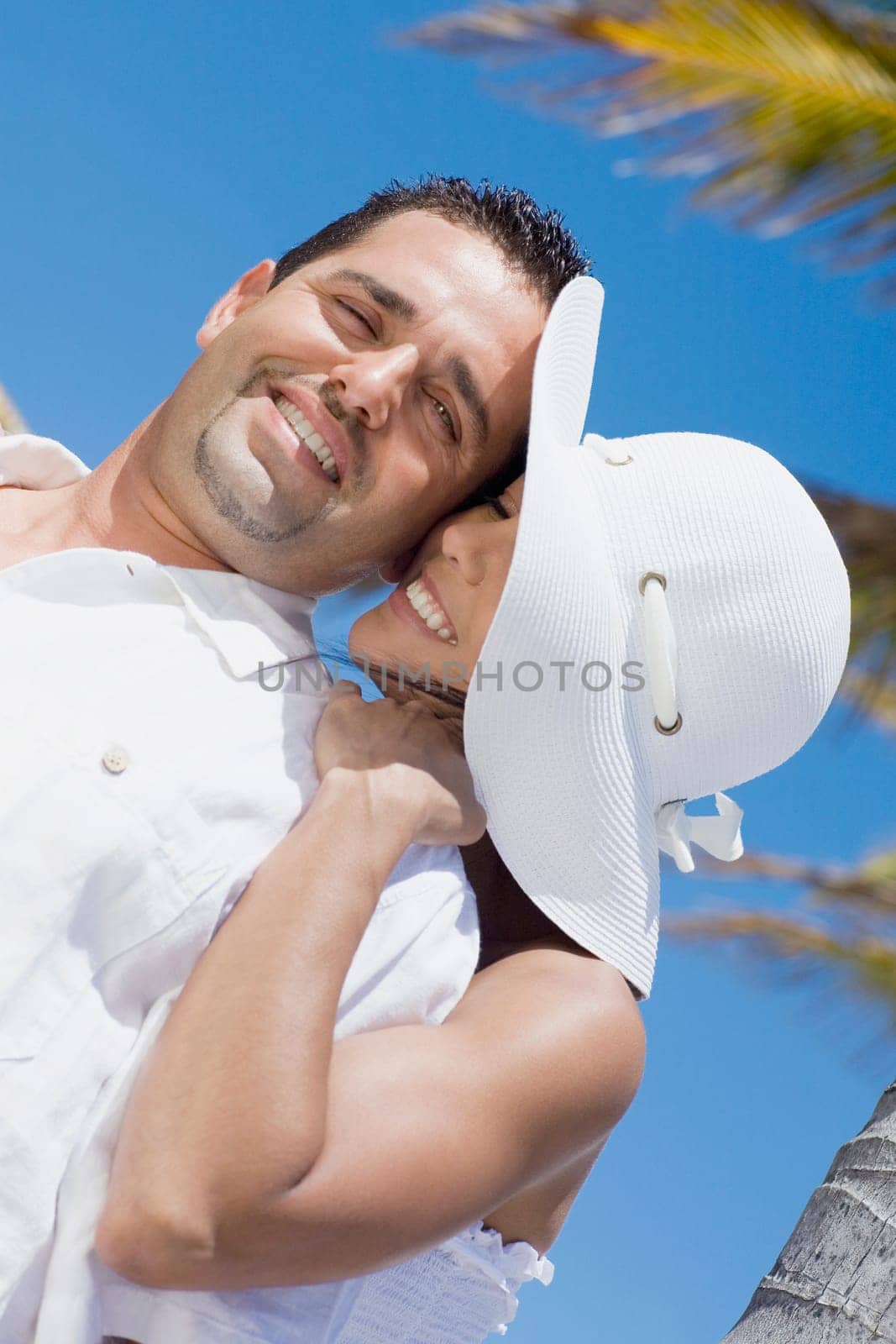 Mid adult woman embracing a mid adult man from behind
