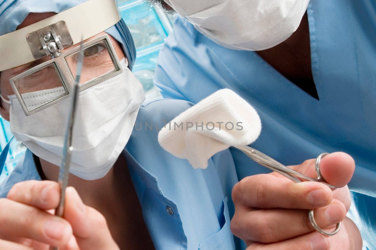 Two surgeons holding surgical scissors
