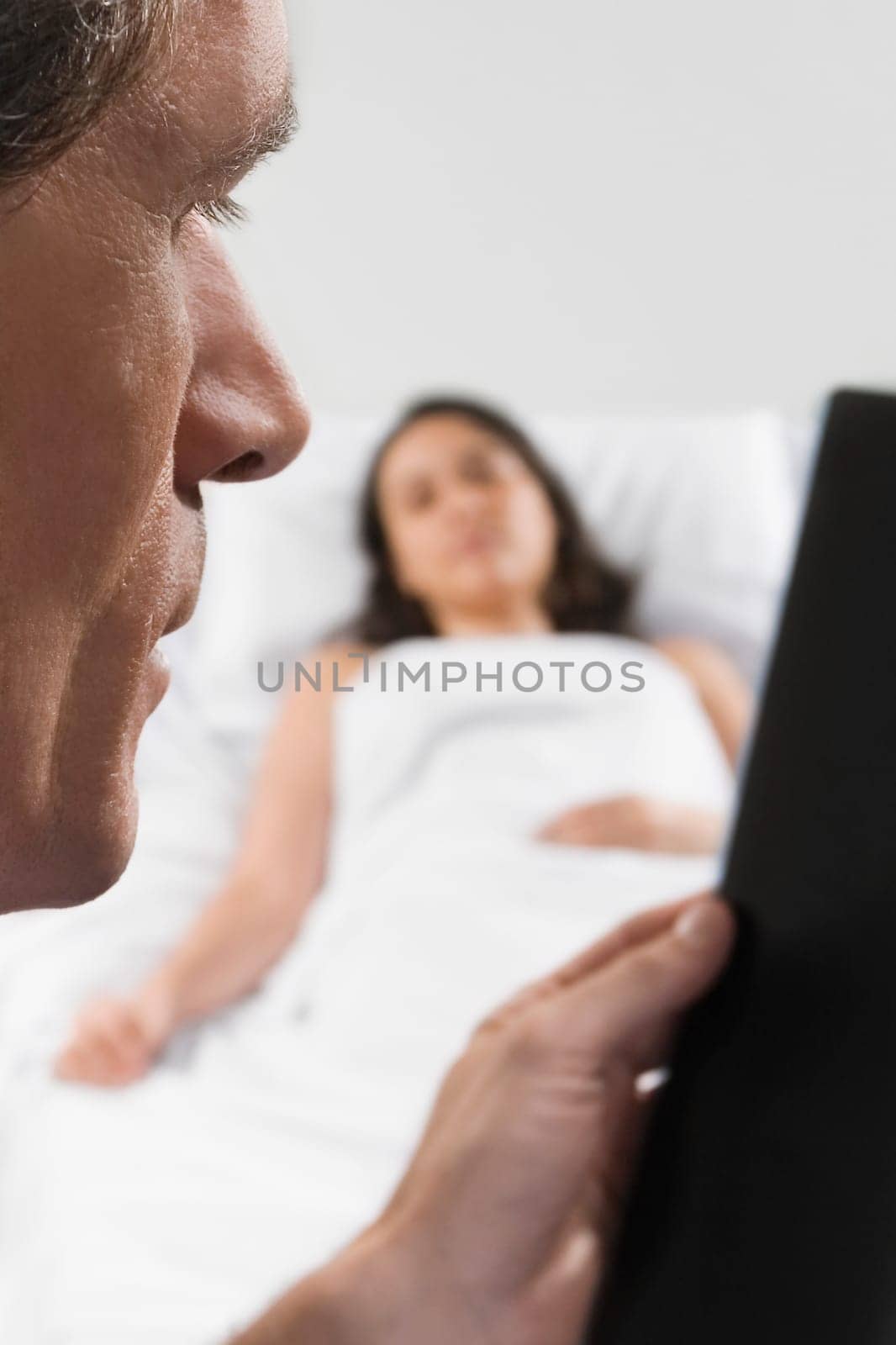 Male doctor examining an X_Ray report