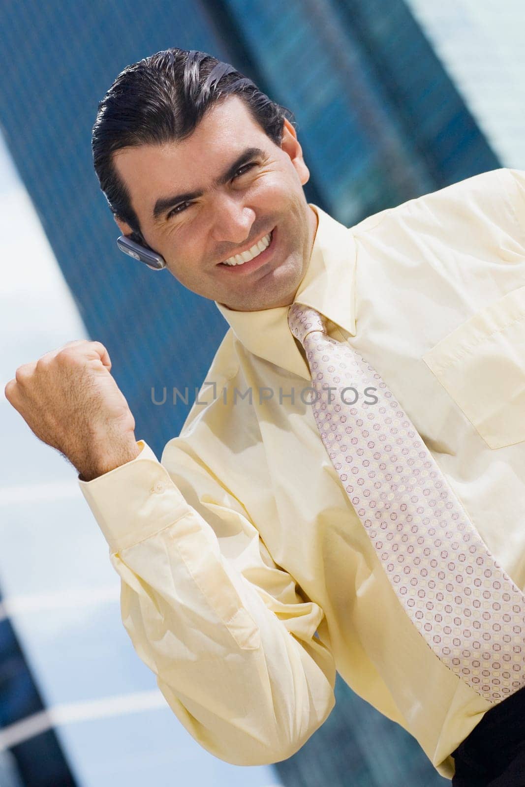 Portrait of a businessman raising his fist and smiling