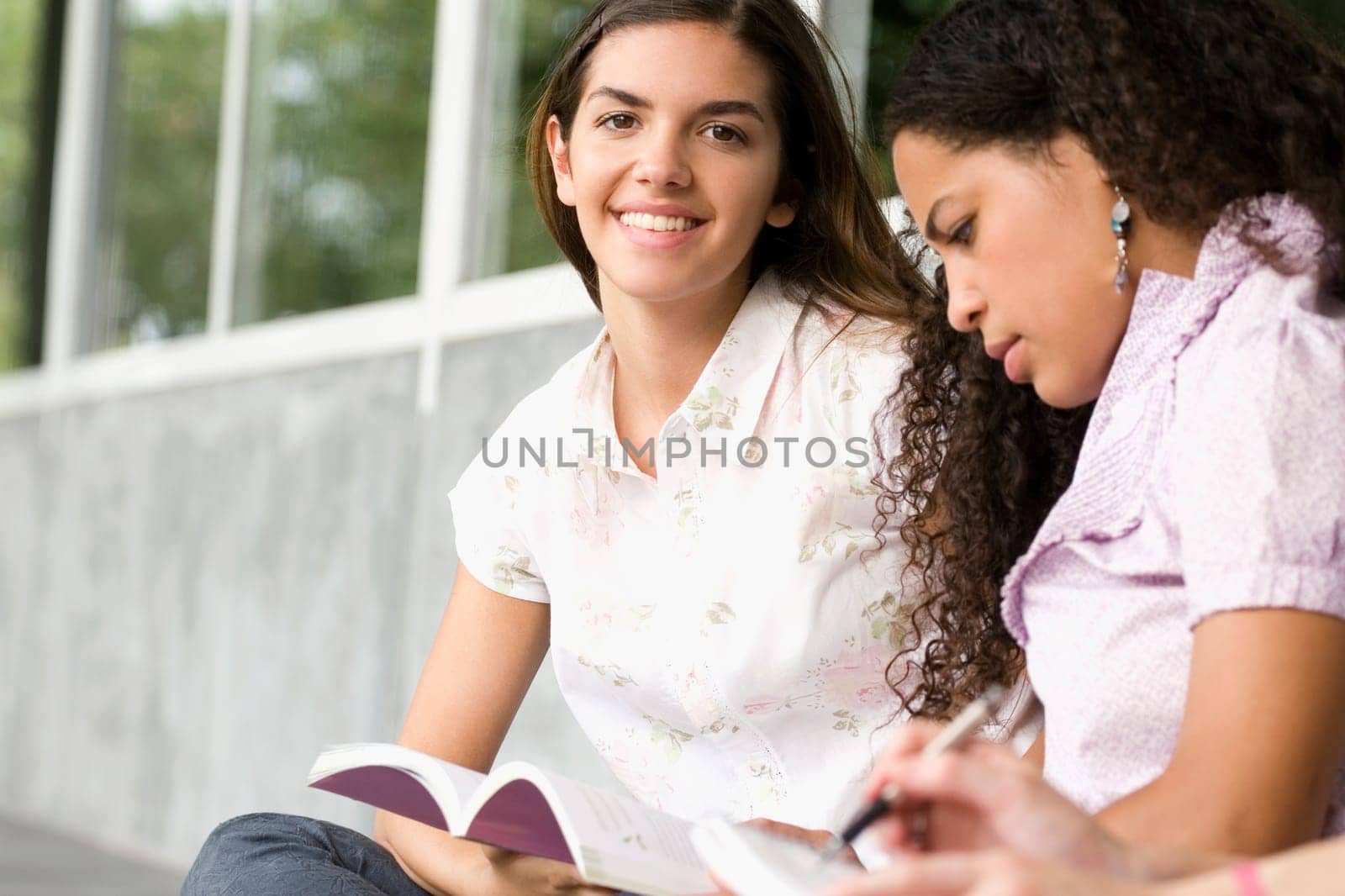 Two university students studying in a corridor