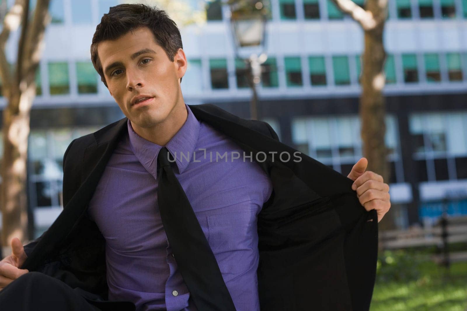 Portrait of a businessman putting off his coat