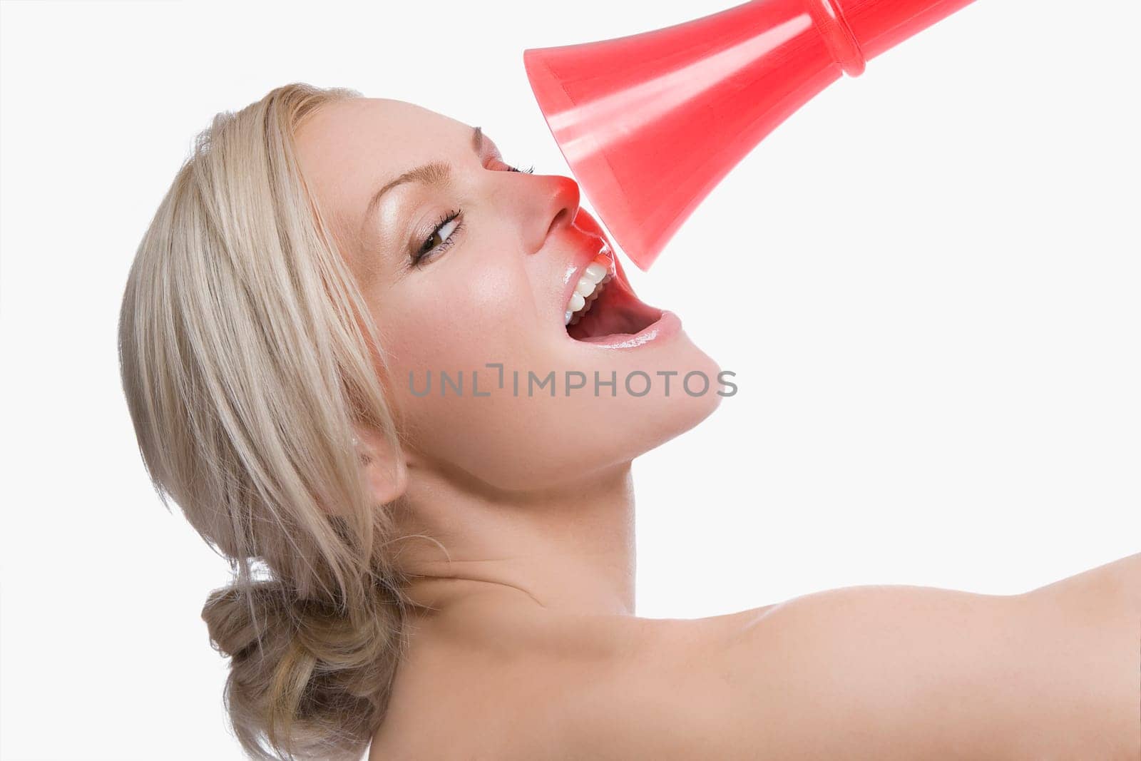 Close_up of a young woman holding a megaphone in front of her face