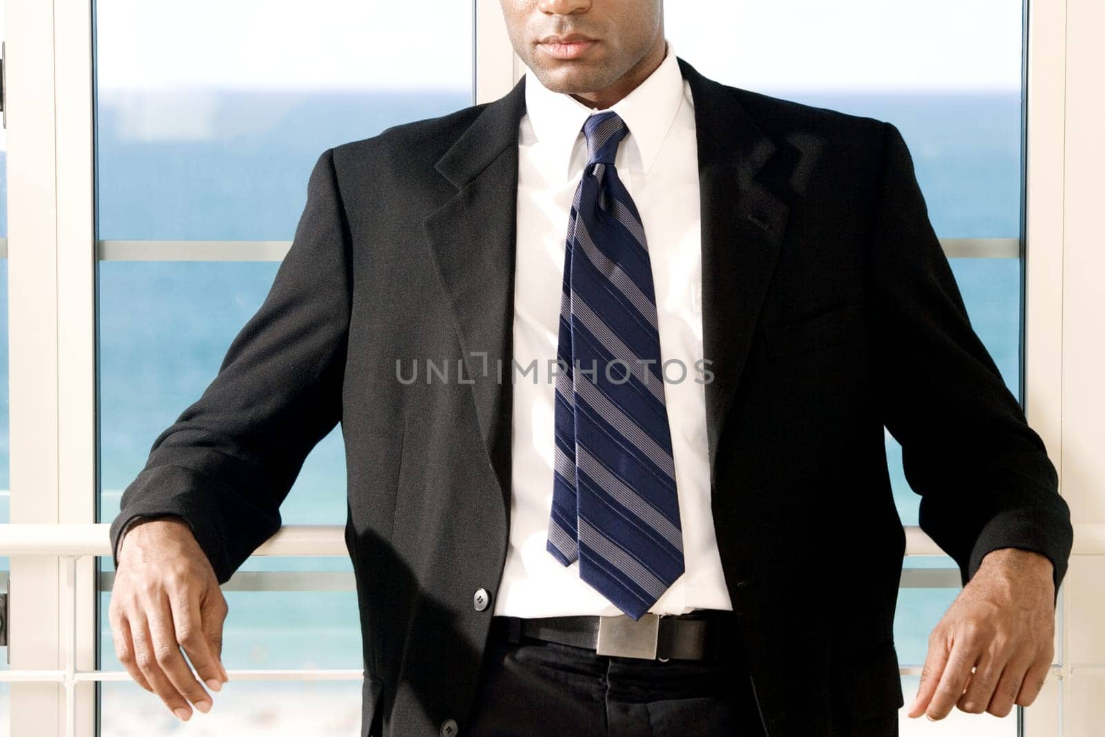 Close-up of a businessman leaning against a railing