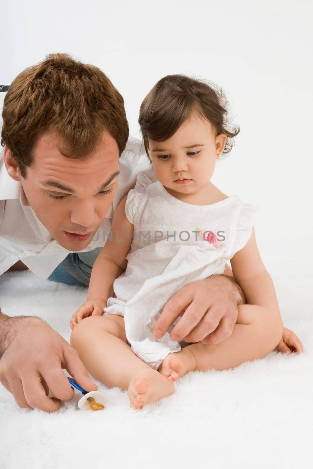 Close_up of a young man playing with his daughter