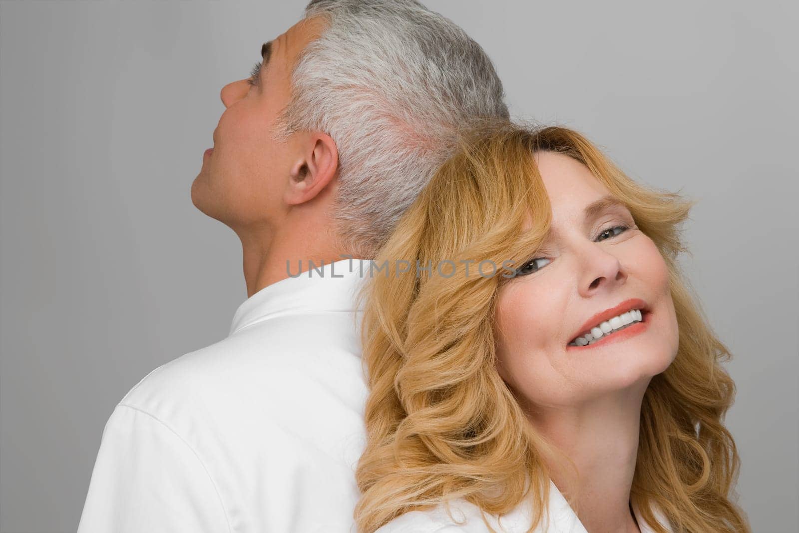 Close_up of a mature couple back to back