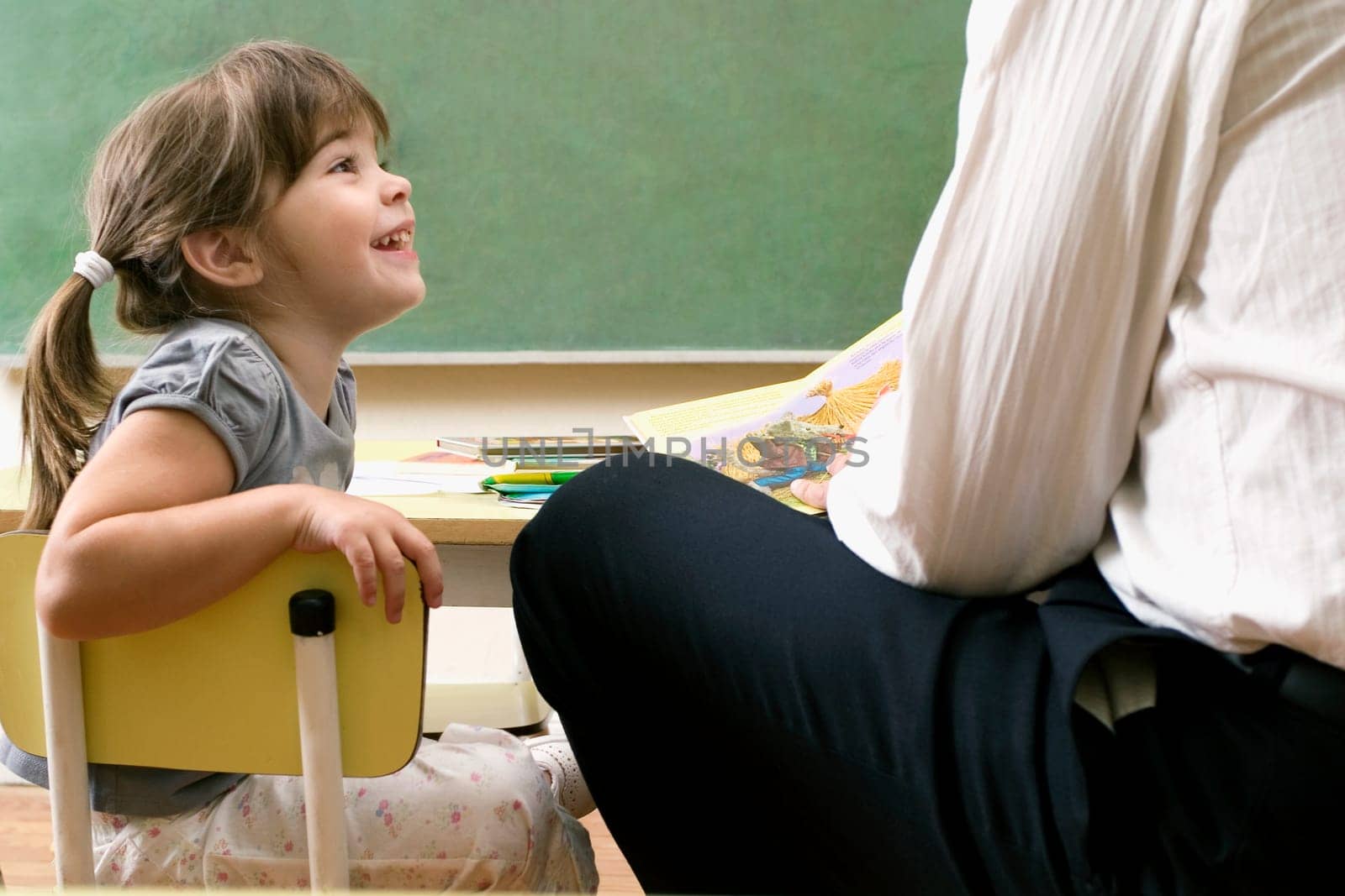 Male teacher teaching his student in a classroom