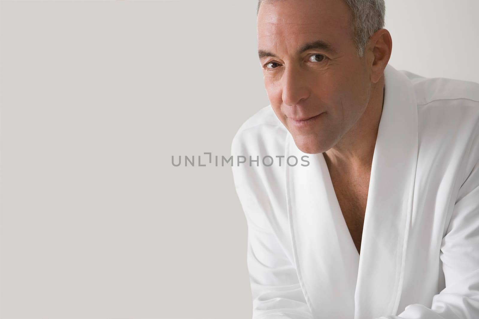 Portrait of a senior man wearing a bathrobe and smiling