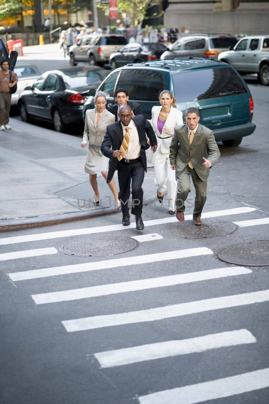 High angle view of five business executives running on the road