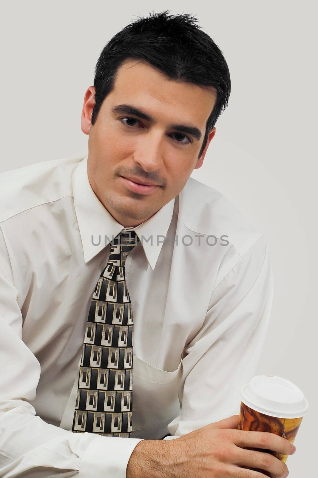 Portrait of a businessman holding a disposable cup