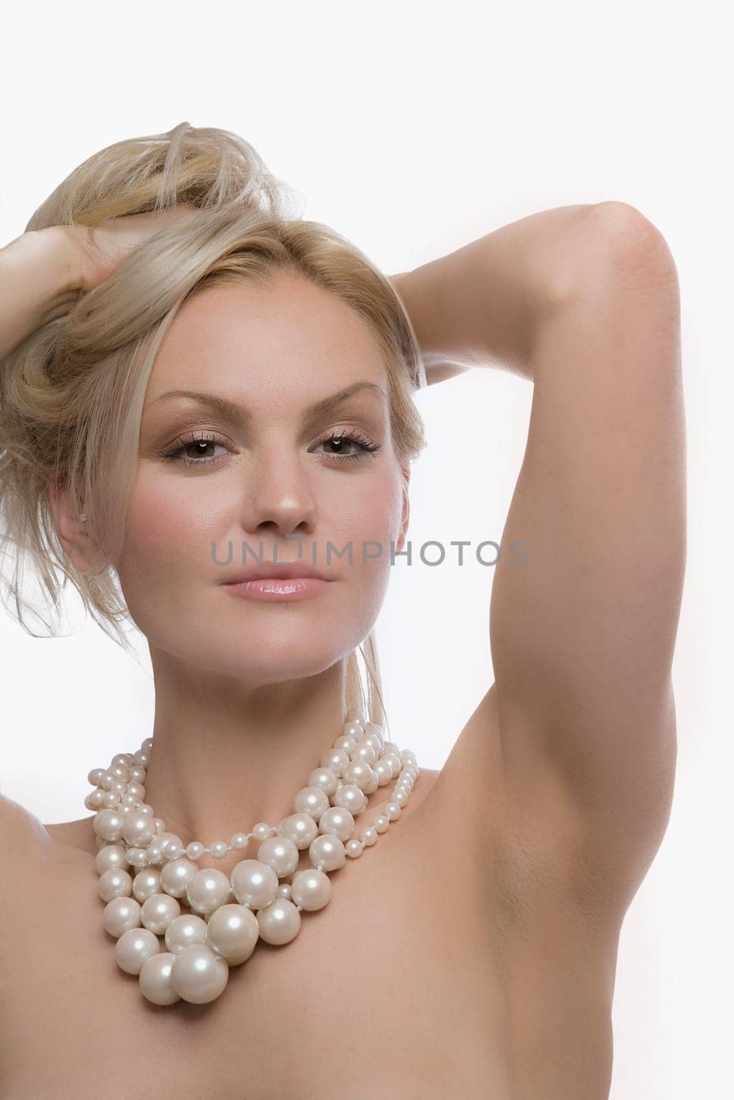 Portrait of a young woman with her hand in her hair