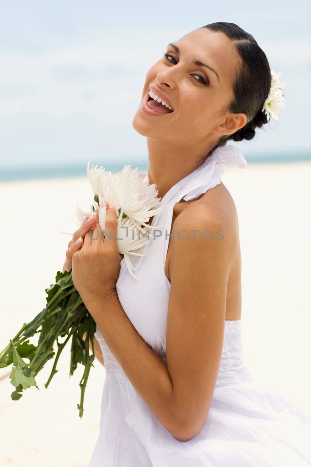 Portrait of a young woman holding flowers and laughing