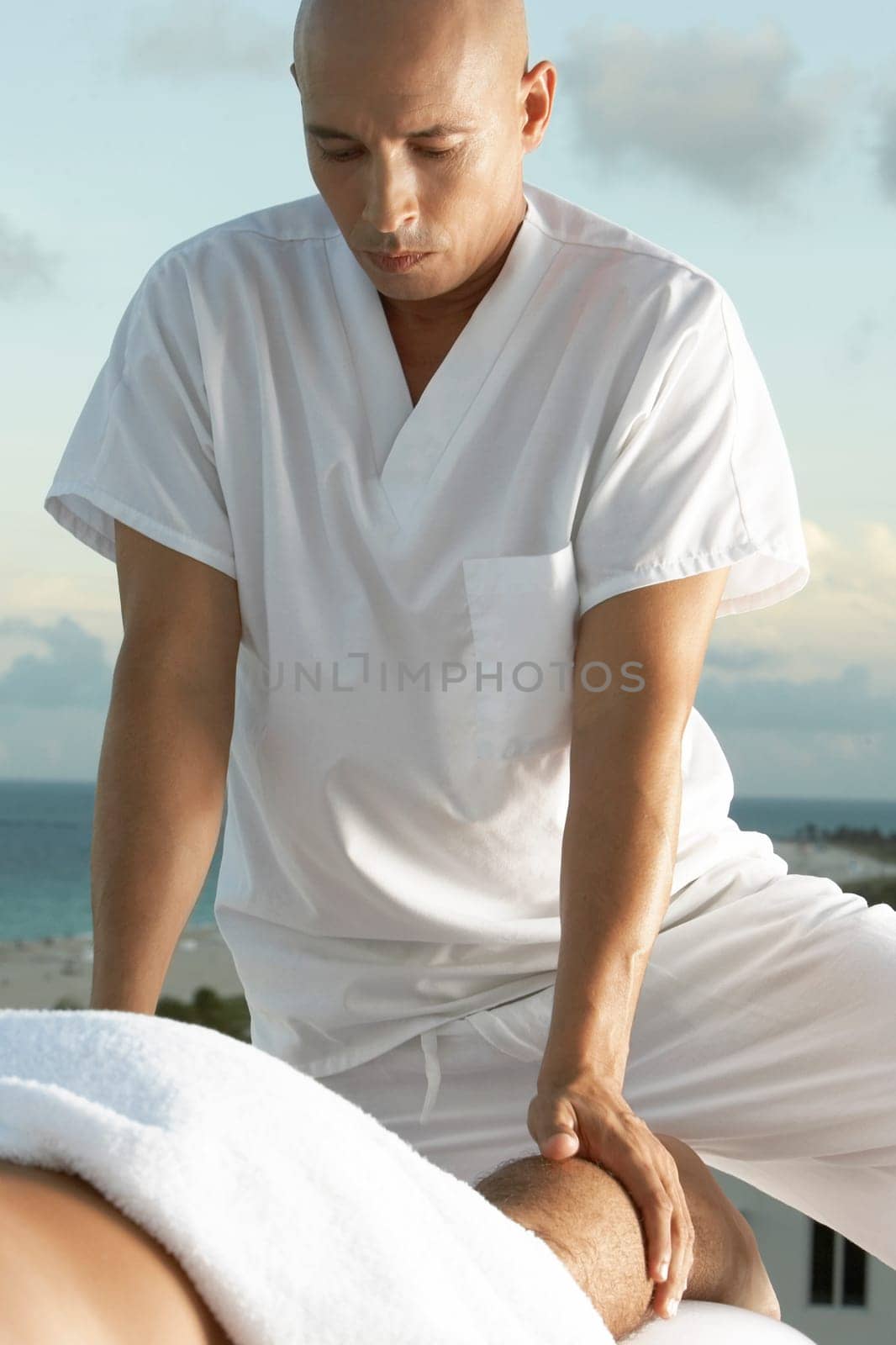 Close-up of a mature man massaging a manŽs legs