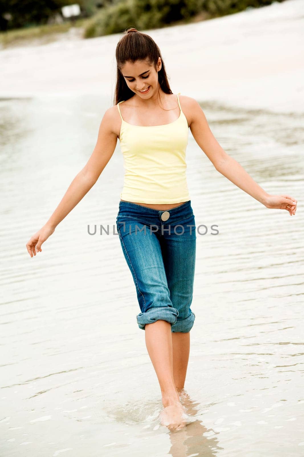 Girl wading in water on the beach
