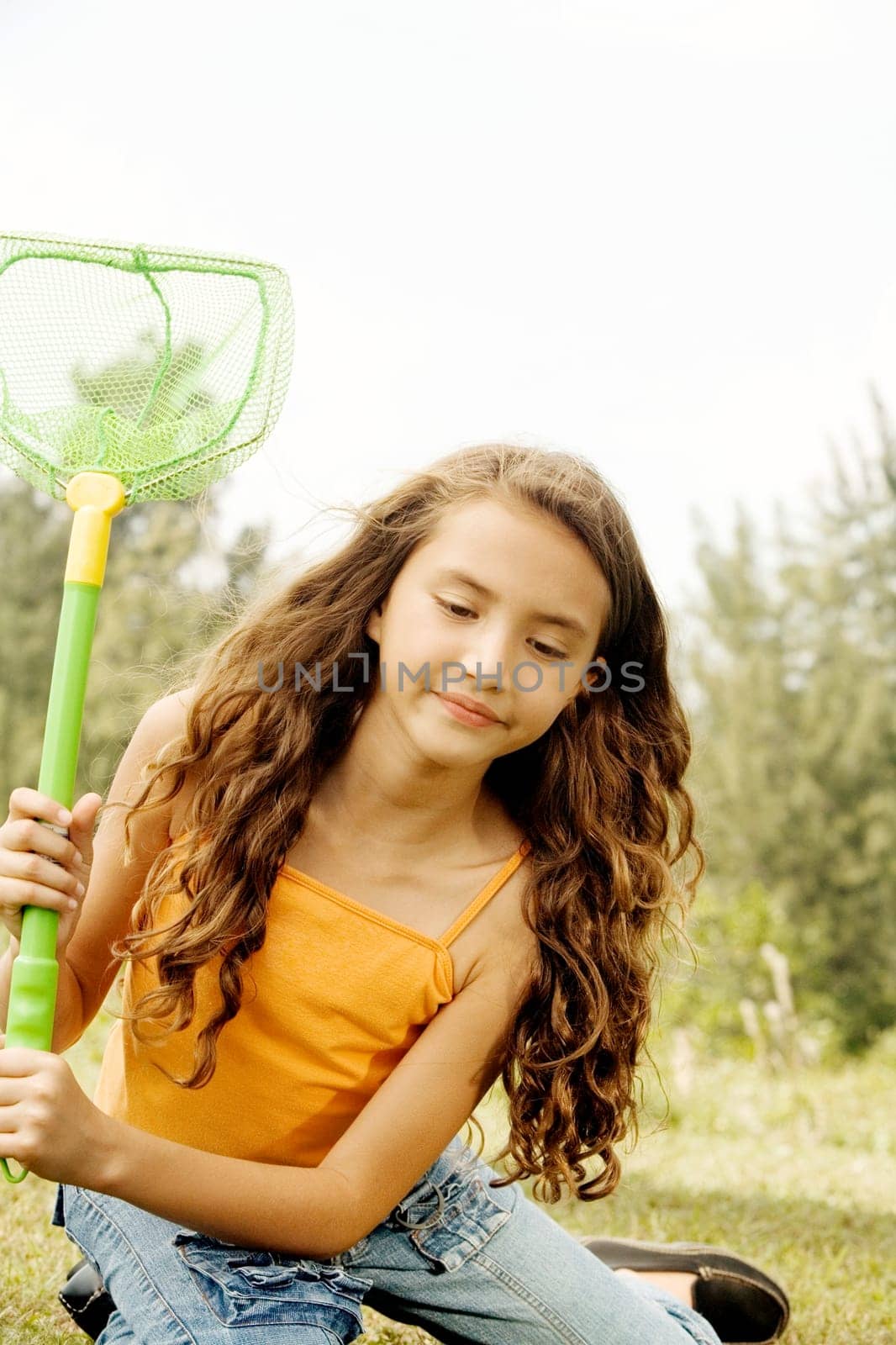 Close-up of a girl sitting holding a butterfly net