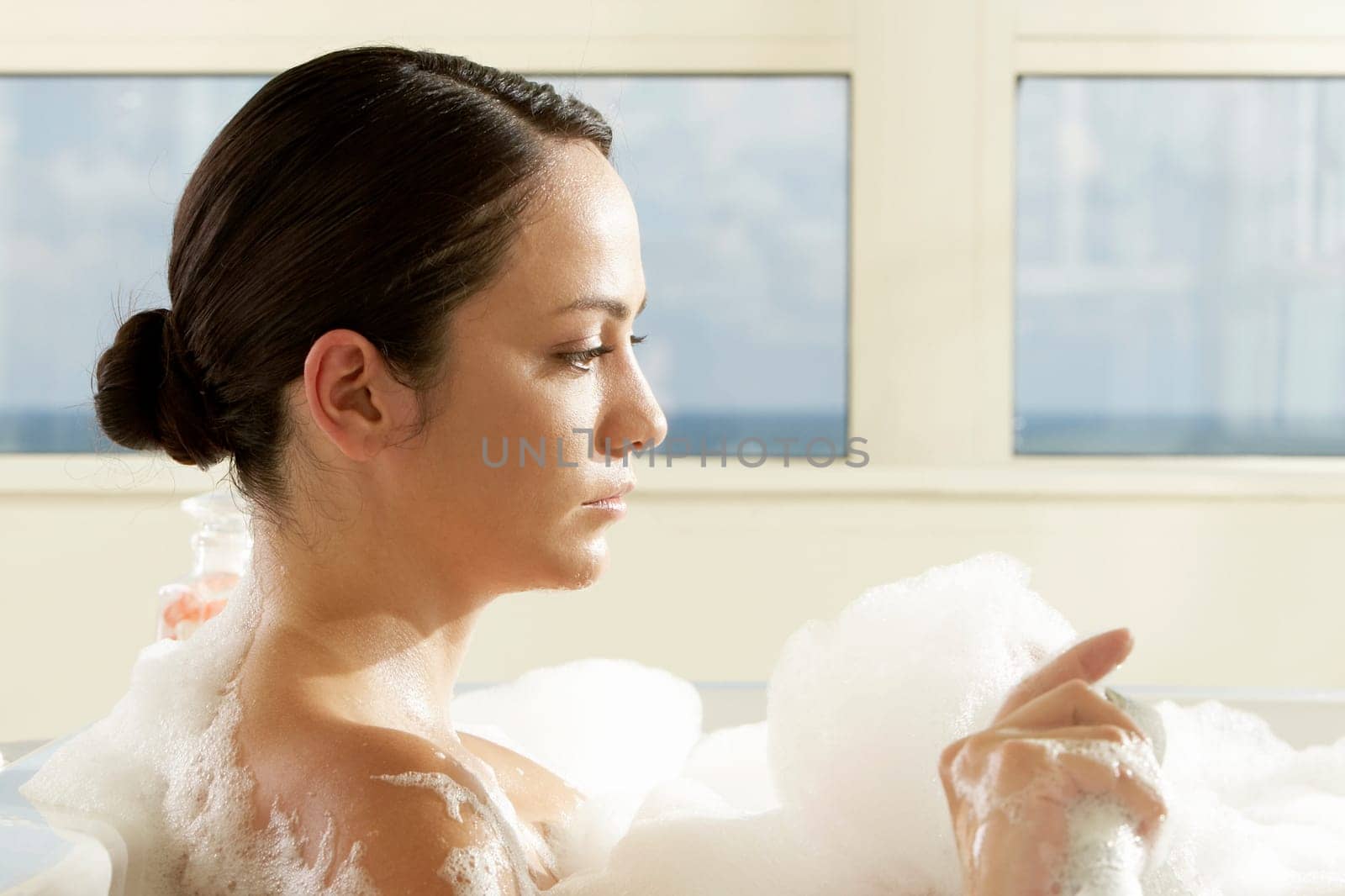 Side profile of a young woman in a bathtub