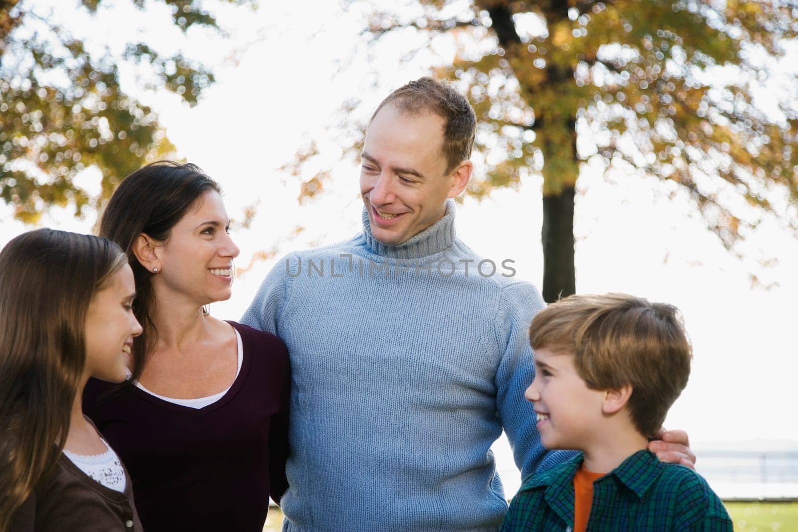 Couple and their two children standing together and smiling
