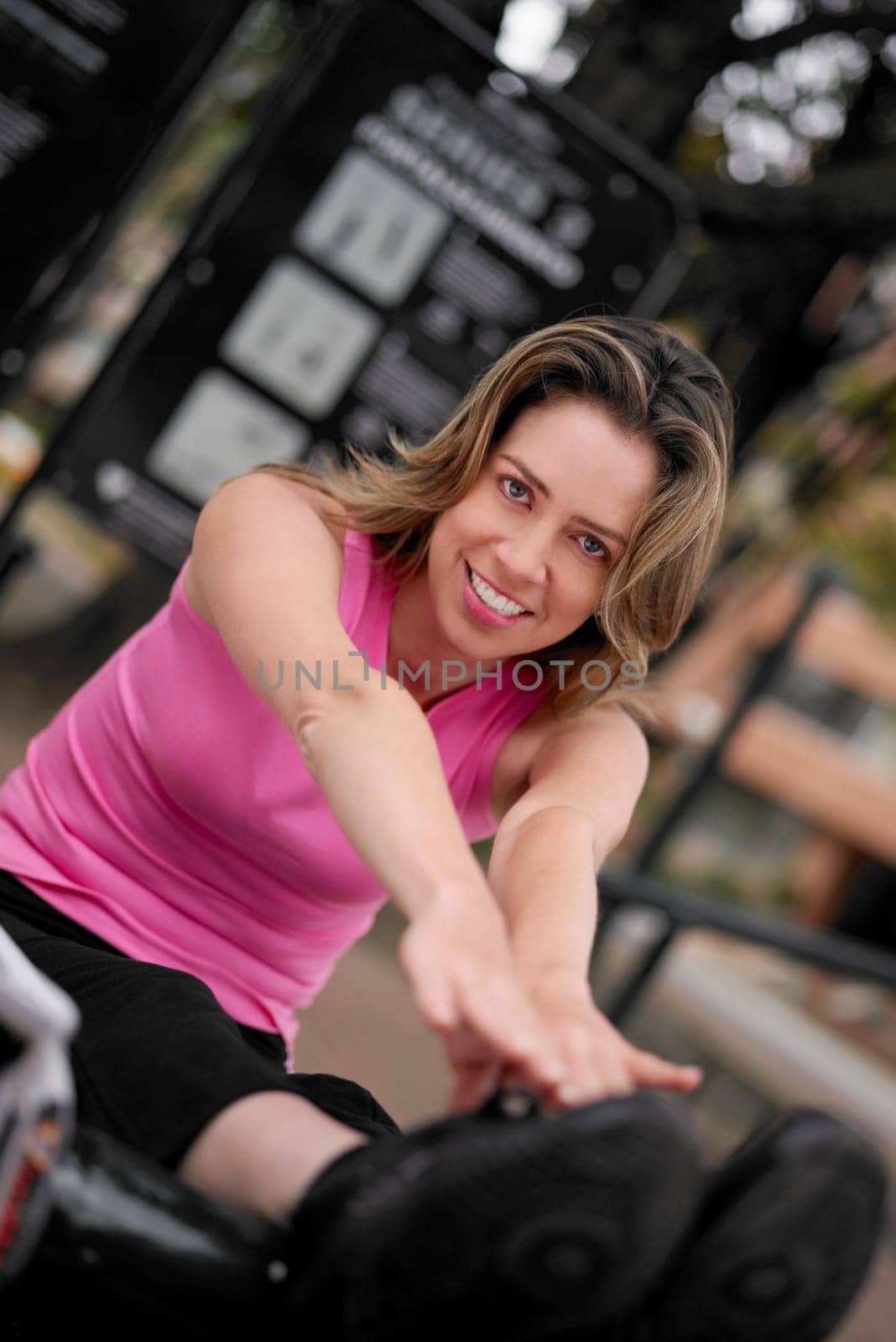 Portrait of a young woman doing sit-ups and touching her toes