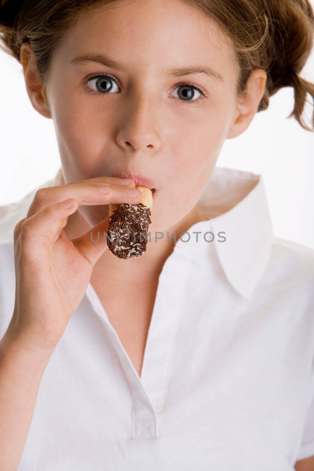 Portrait of a girl eating a pastry