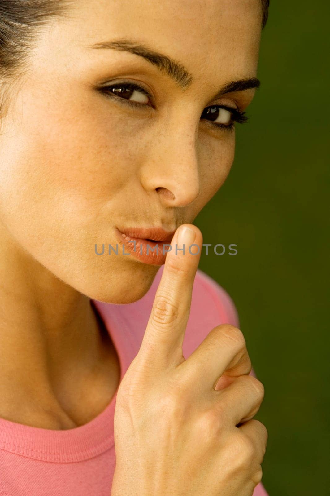 Portrait of a mid adult woman with her finger on her lips