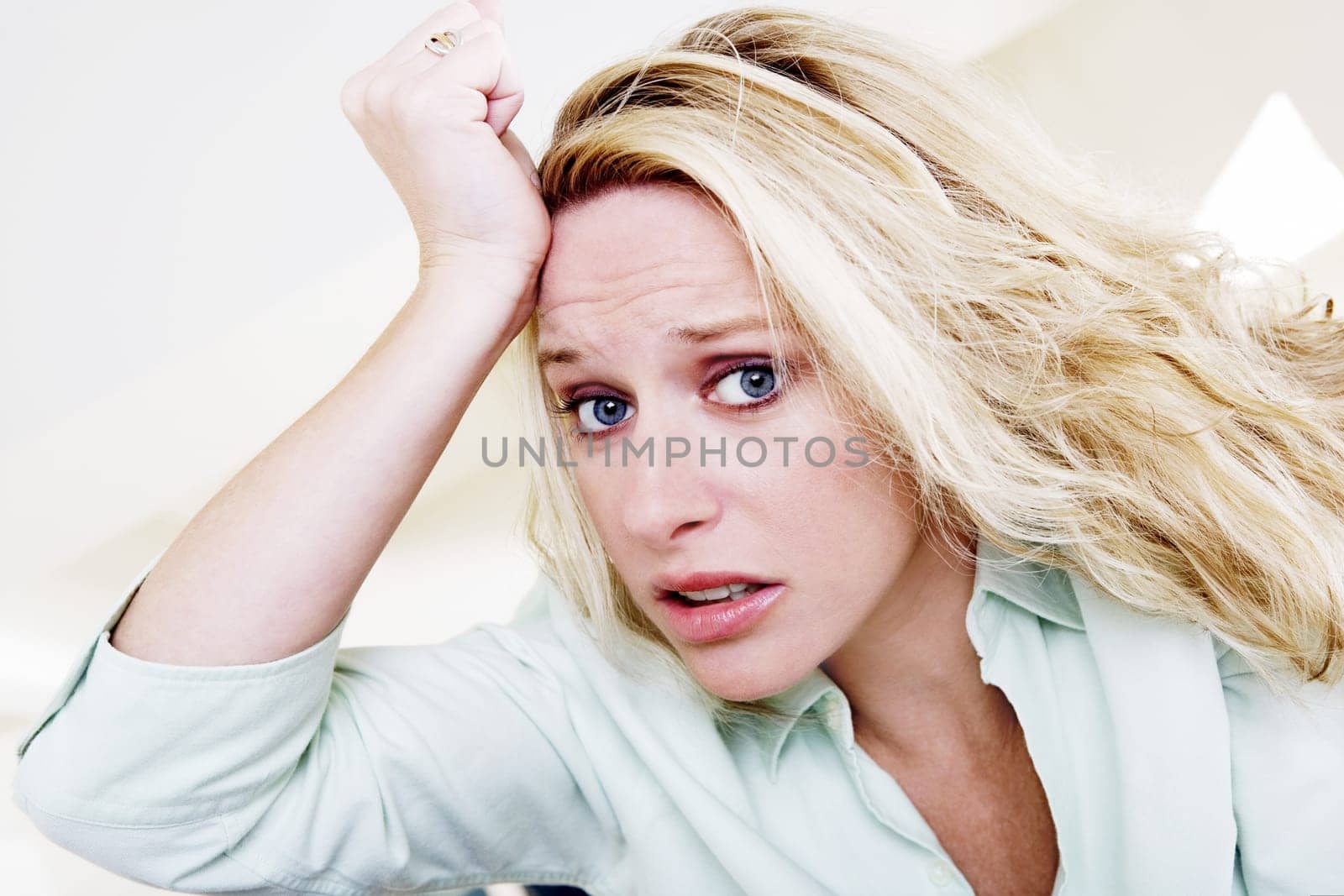 Young woman with her hand on her head