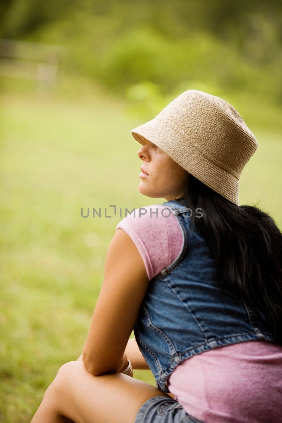 Rear view of a young woman in the garden